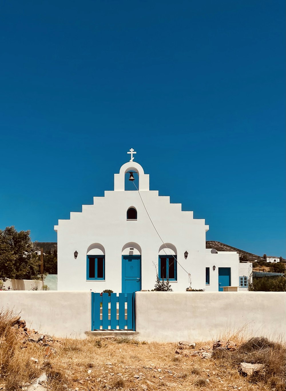 a white building with a blue door