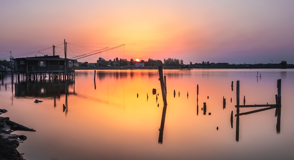 a body of water with a dock and buildings in the background