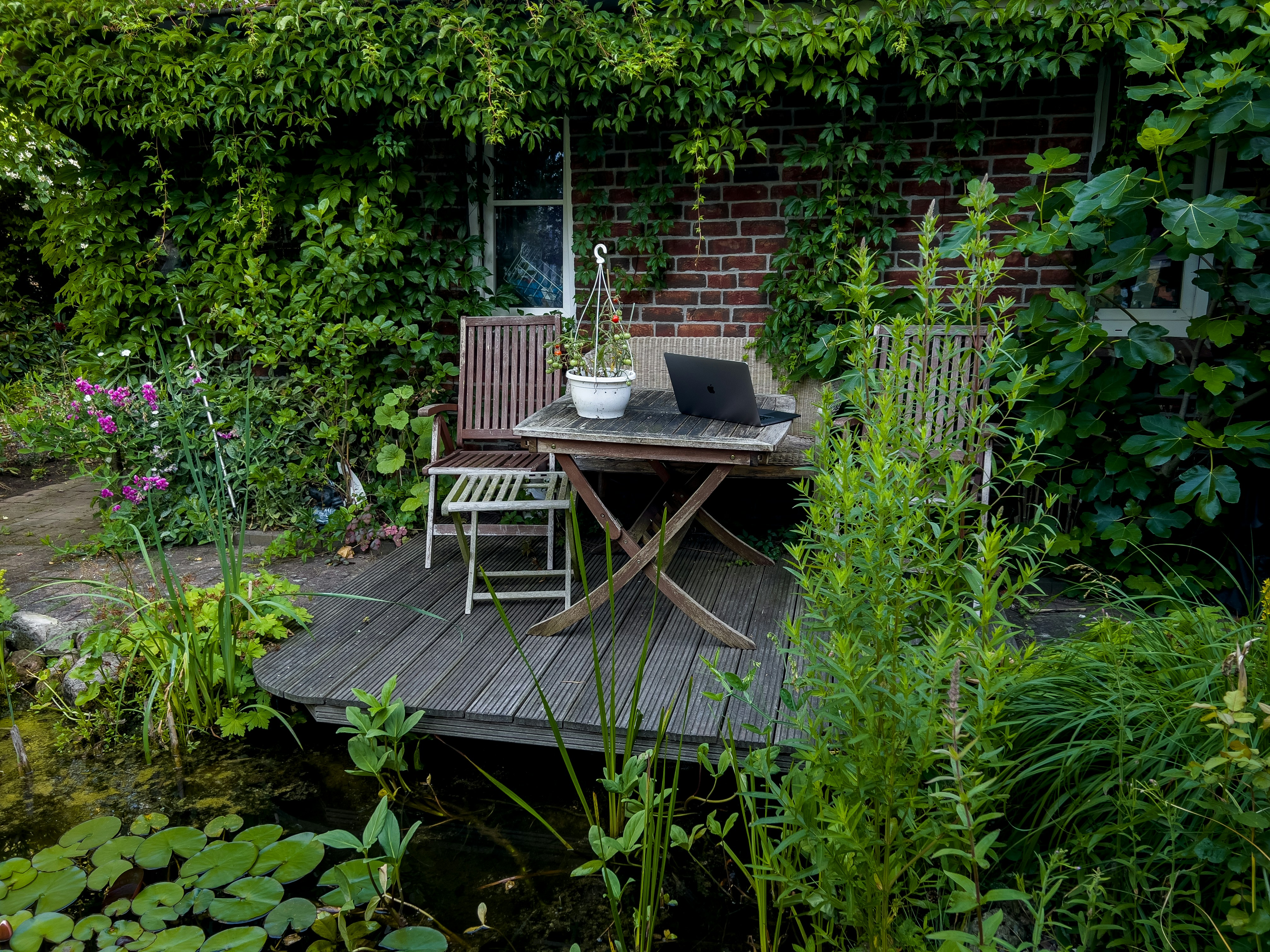 a laptop on a table in a garden