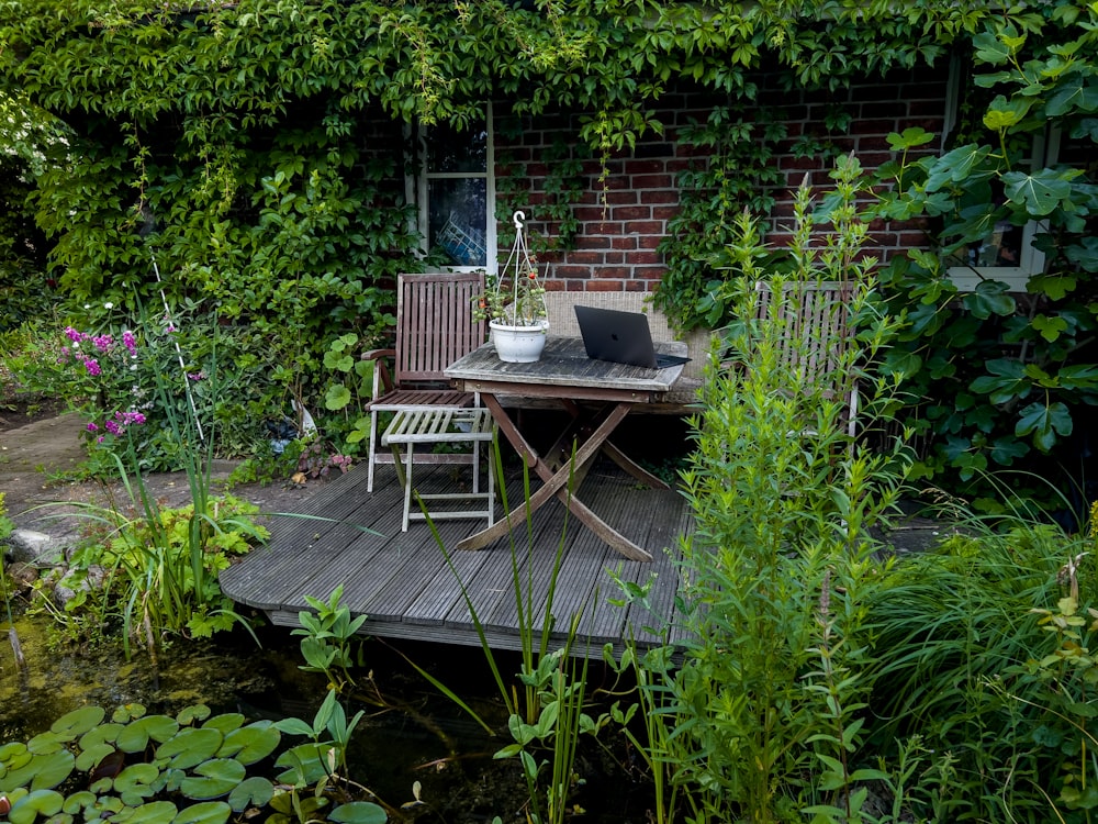 a laptop on a table in a garden