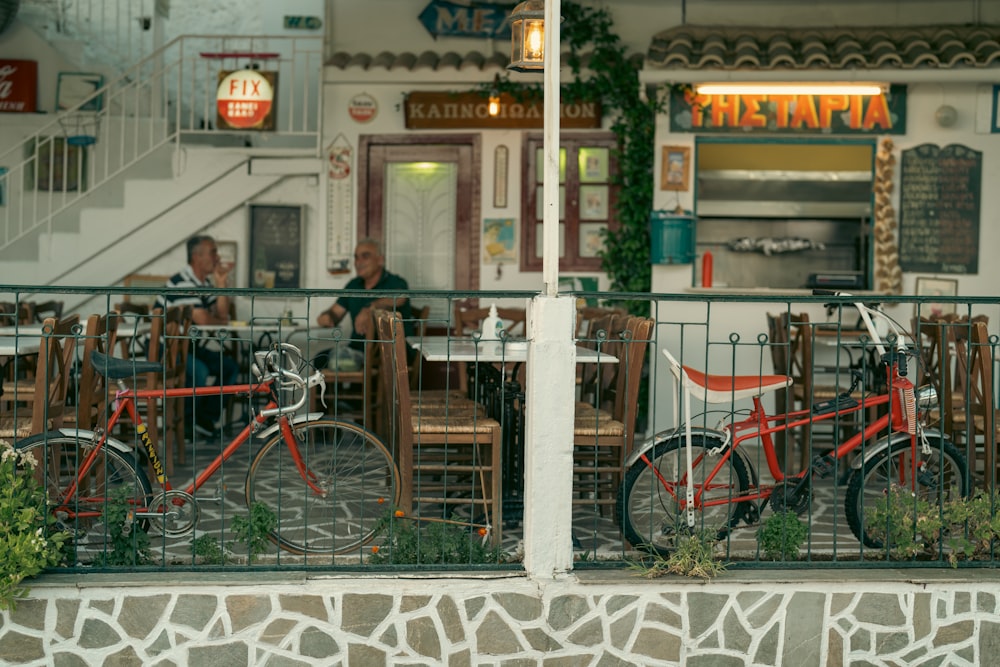 a couple of people sitting at a table in front of a restaurant