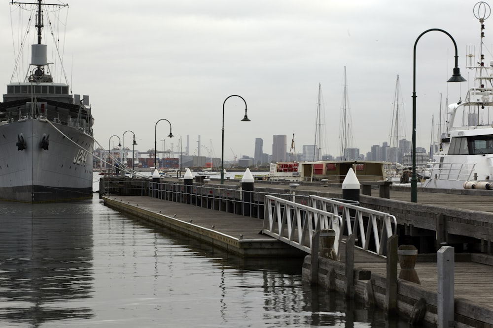 a dock with boats and a city in the background