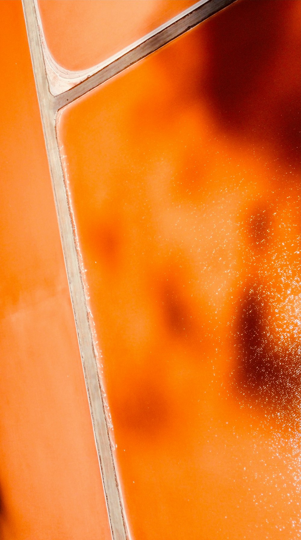 a close up of a red and orange liquid