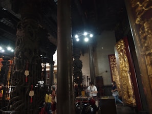 Warmly lit hotel lobby with traditional Varanasi decor and intricate wooden carvings