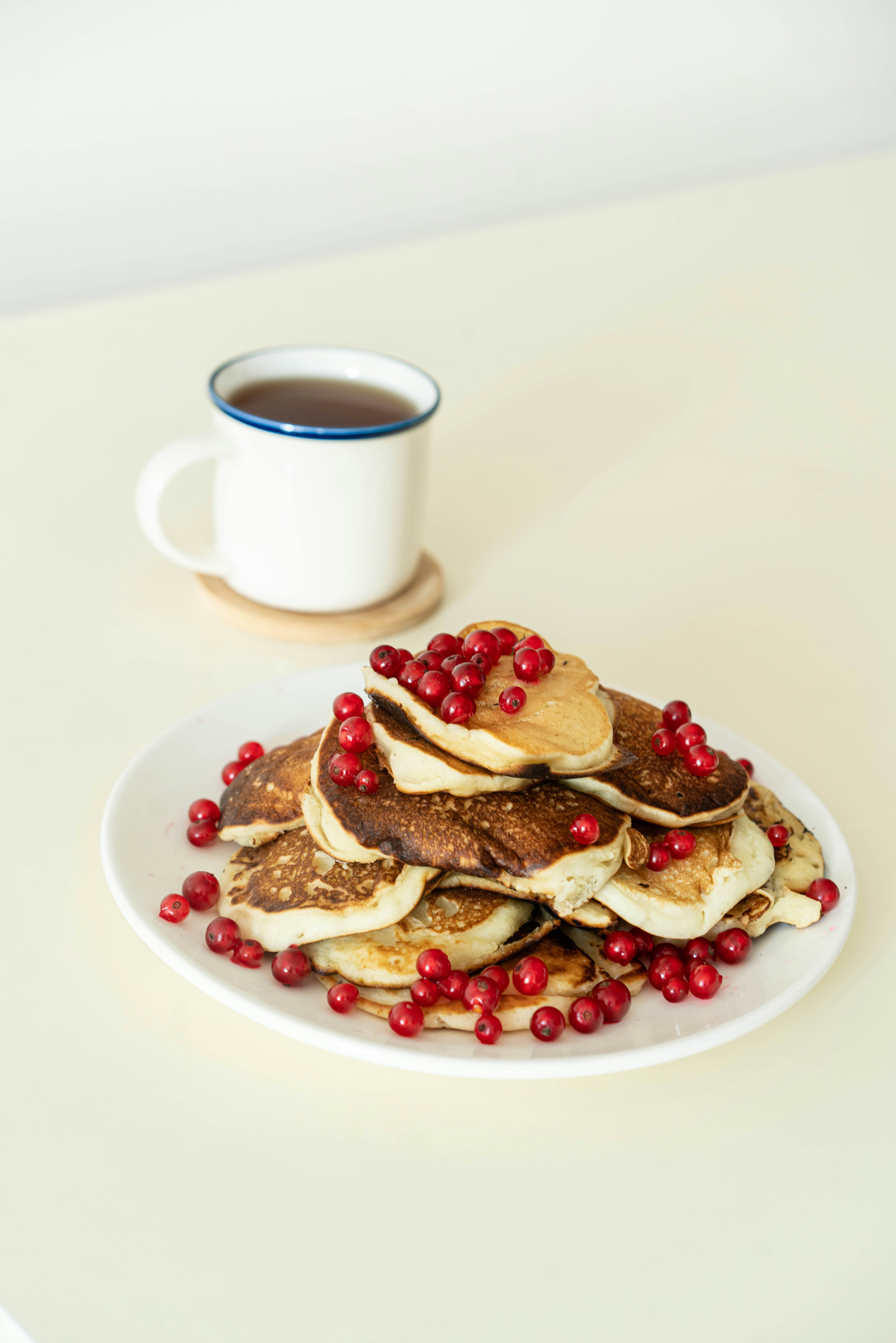 a plate of waffles with a cup of coffee
