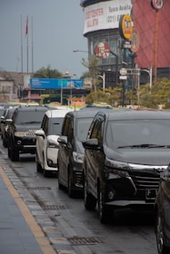 a row of cars parked on the side of a road