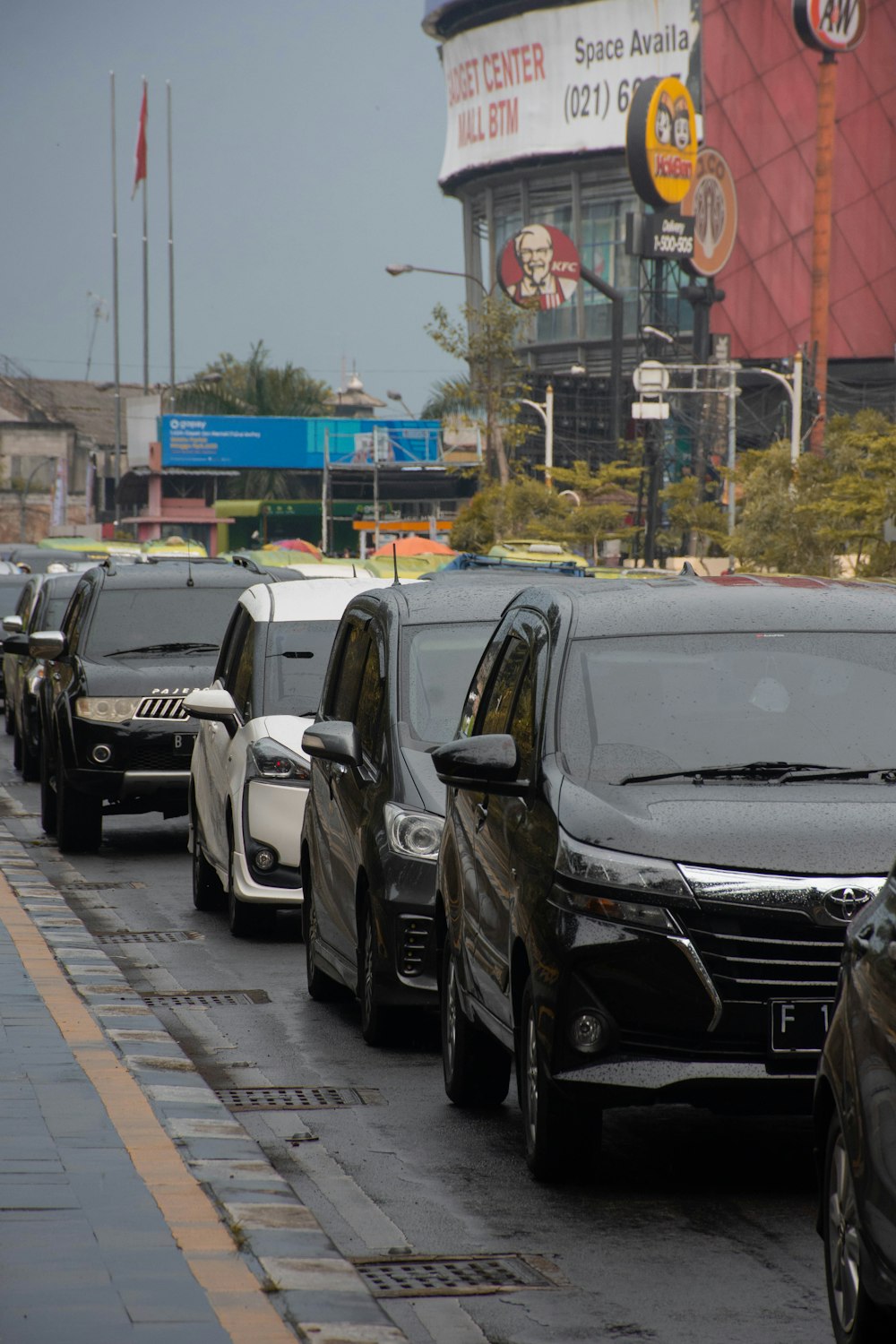 a row of cars parked on the side of a road