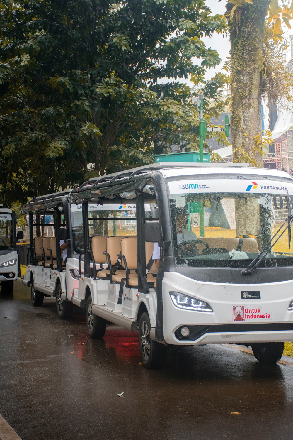 a group of buses are parked in a lot