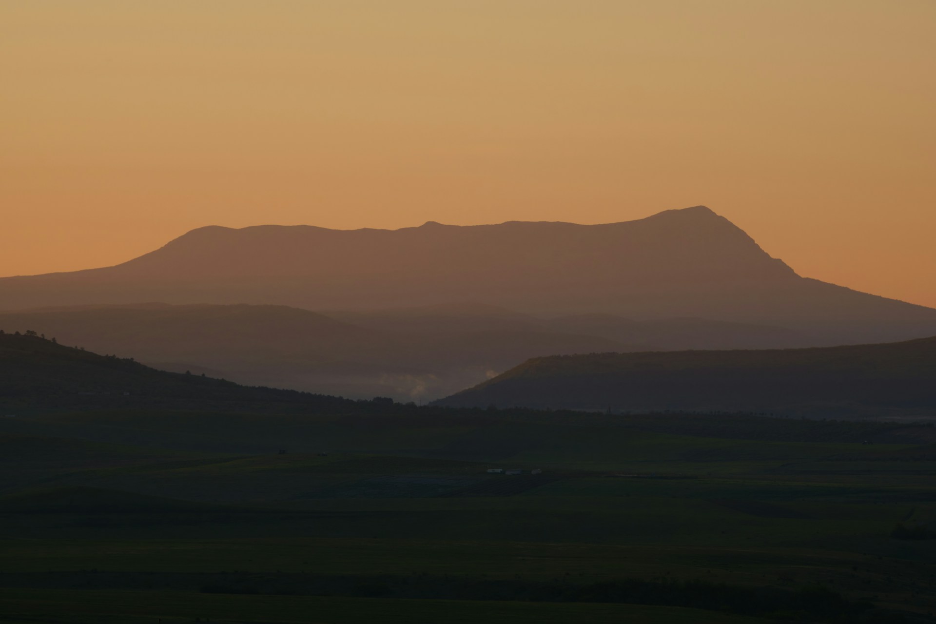 a landscape with hills in the back
