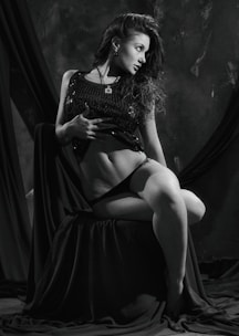 Elegant boudoir portrait with soft lighting highlighting confidence and sensuality.