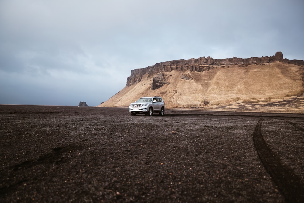 a white car driving on a road