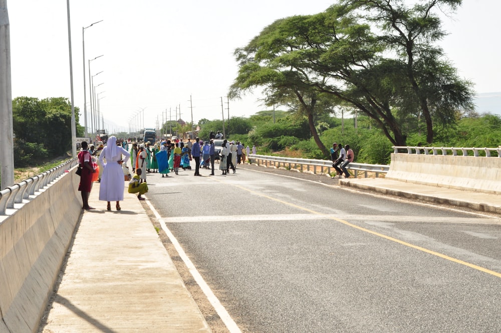 a group of people walking on a road