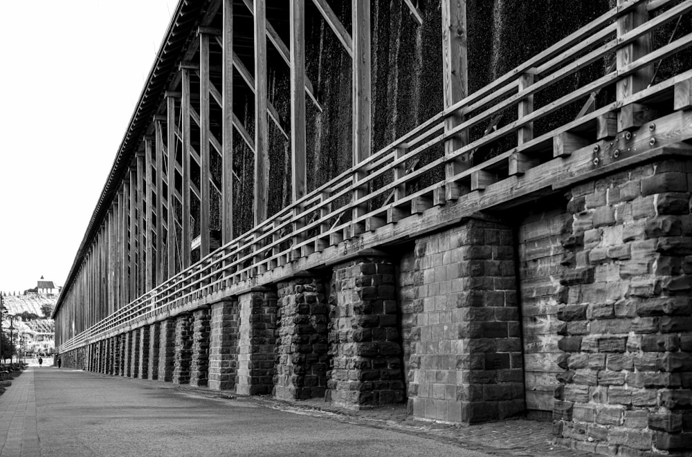 a brick wall with a metal fence