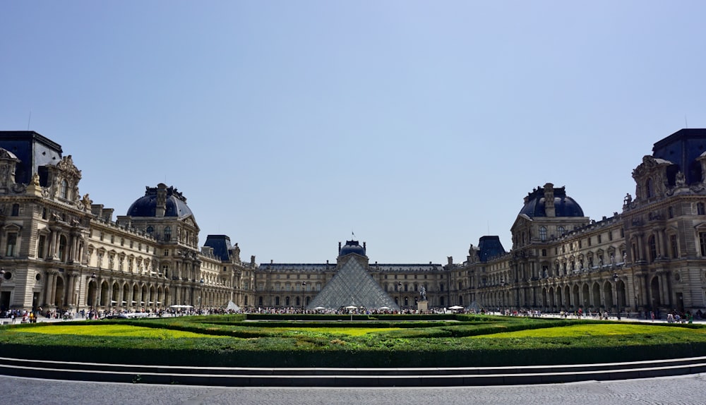 a large building with a lawn in front of it