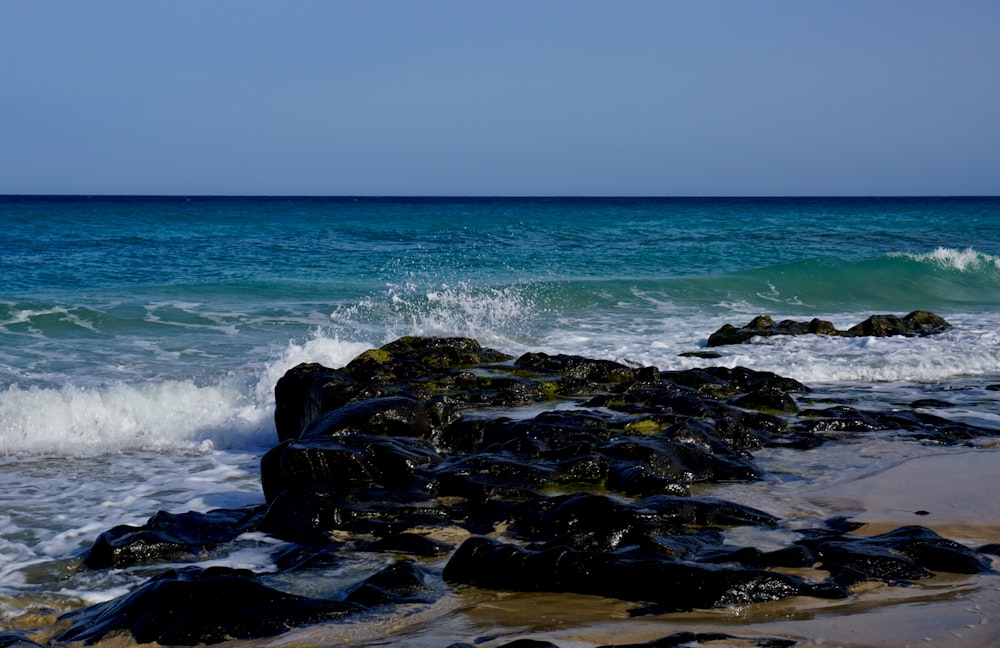 a rocky beach with waves crashing