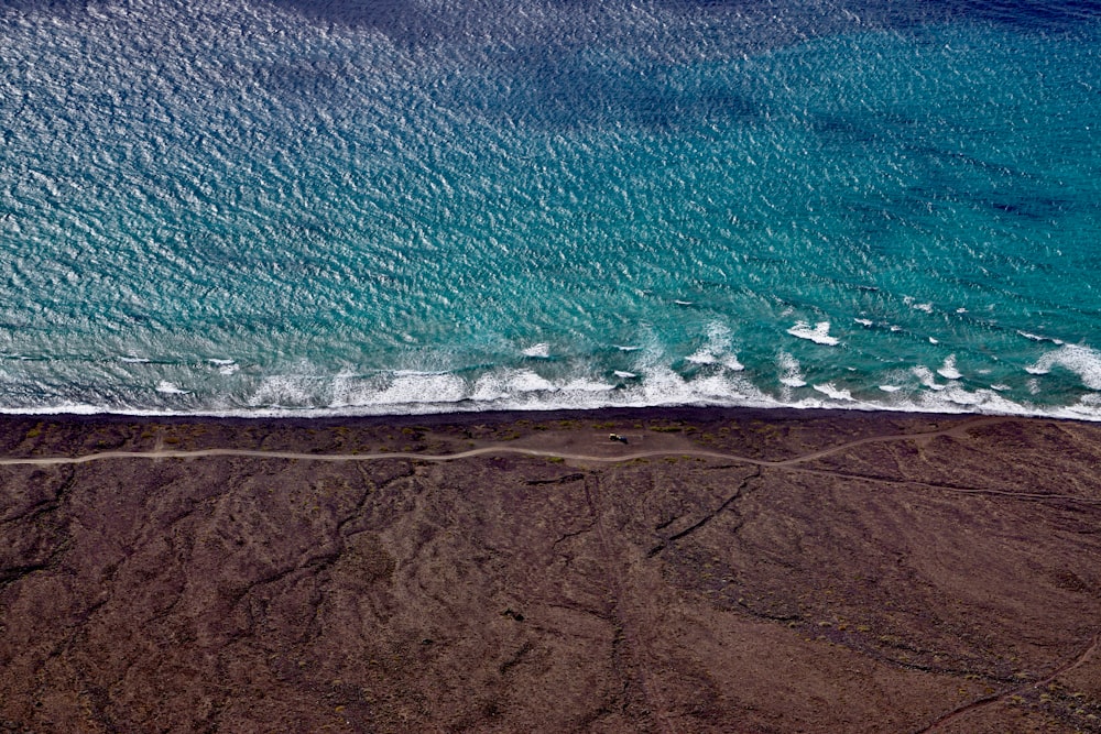 a sandy beach with waves crashing