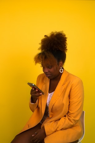 a person sitting in a chair looking at the phone