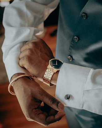 a person's hands with a ring on their wrist
