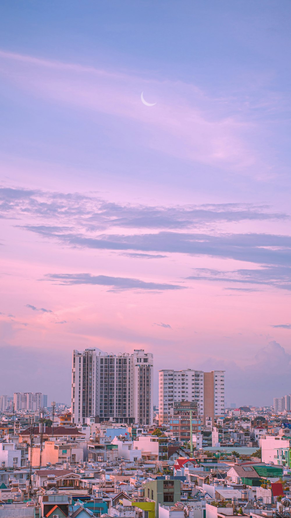 a city with buildings and a blue sky