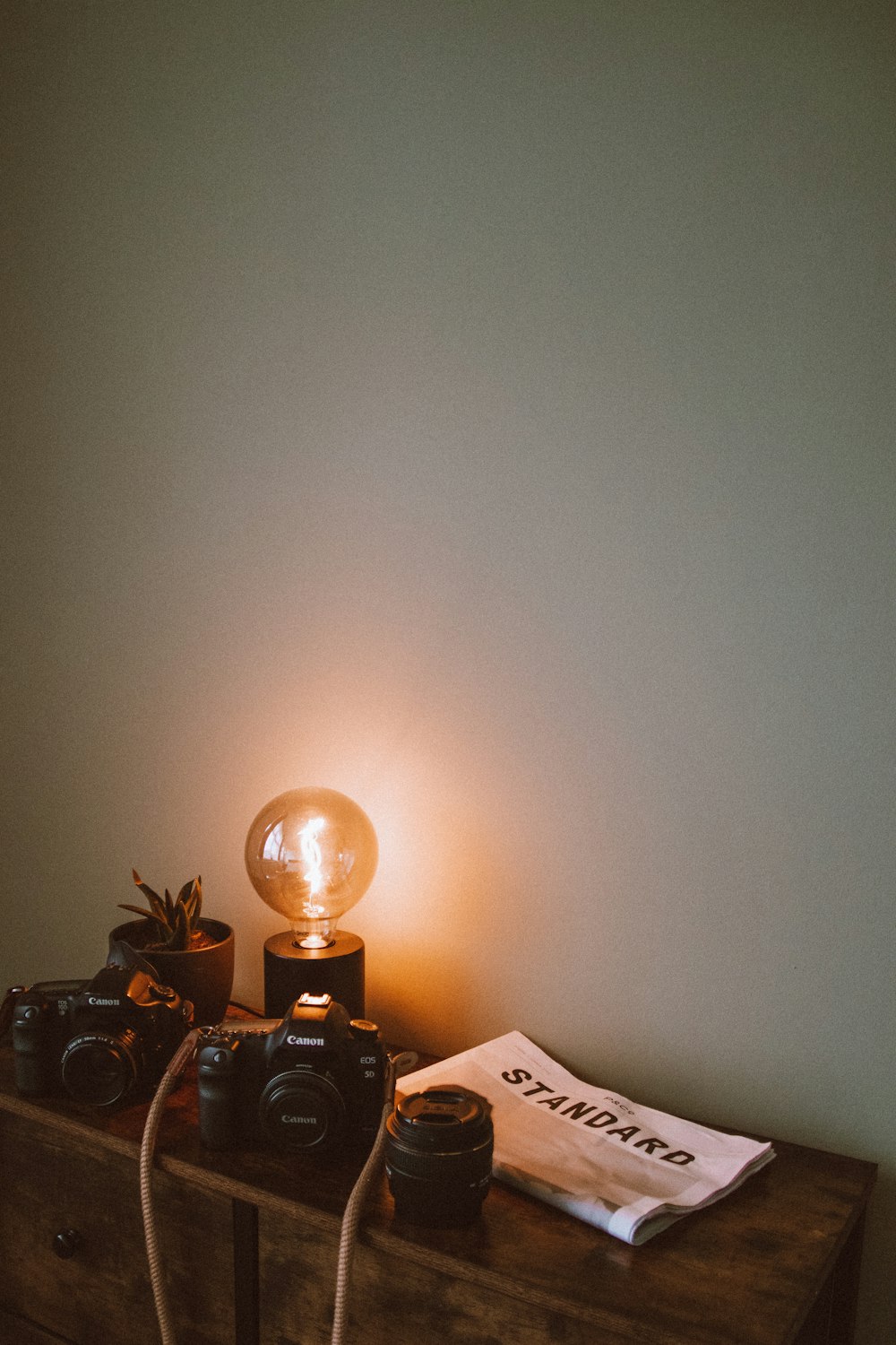 a lamp and camera on a table