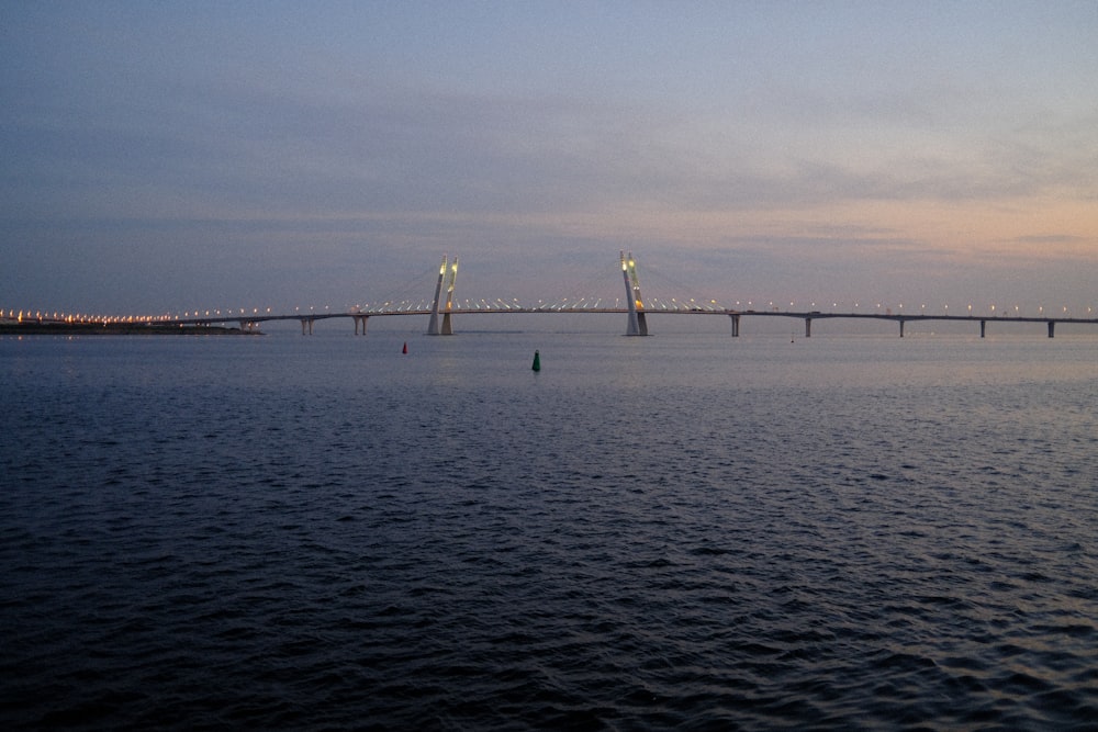 a body of water with a bridge in the distance