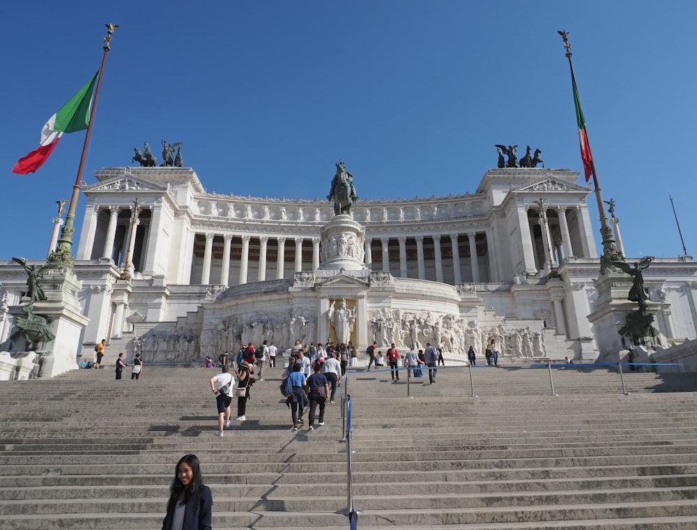 a large white building with columns and a statue in front of it