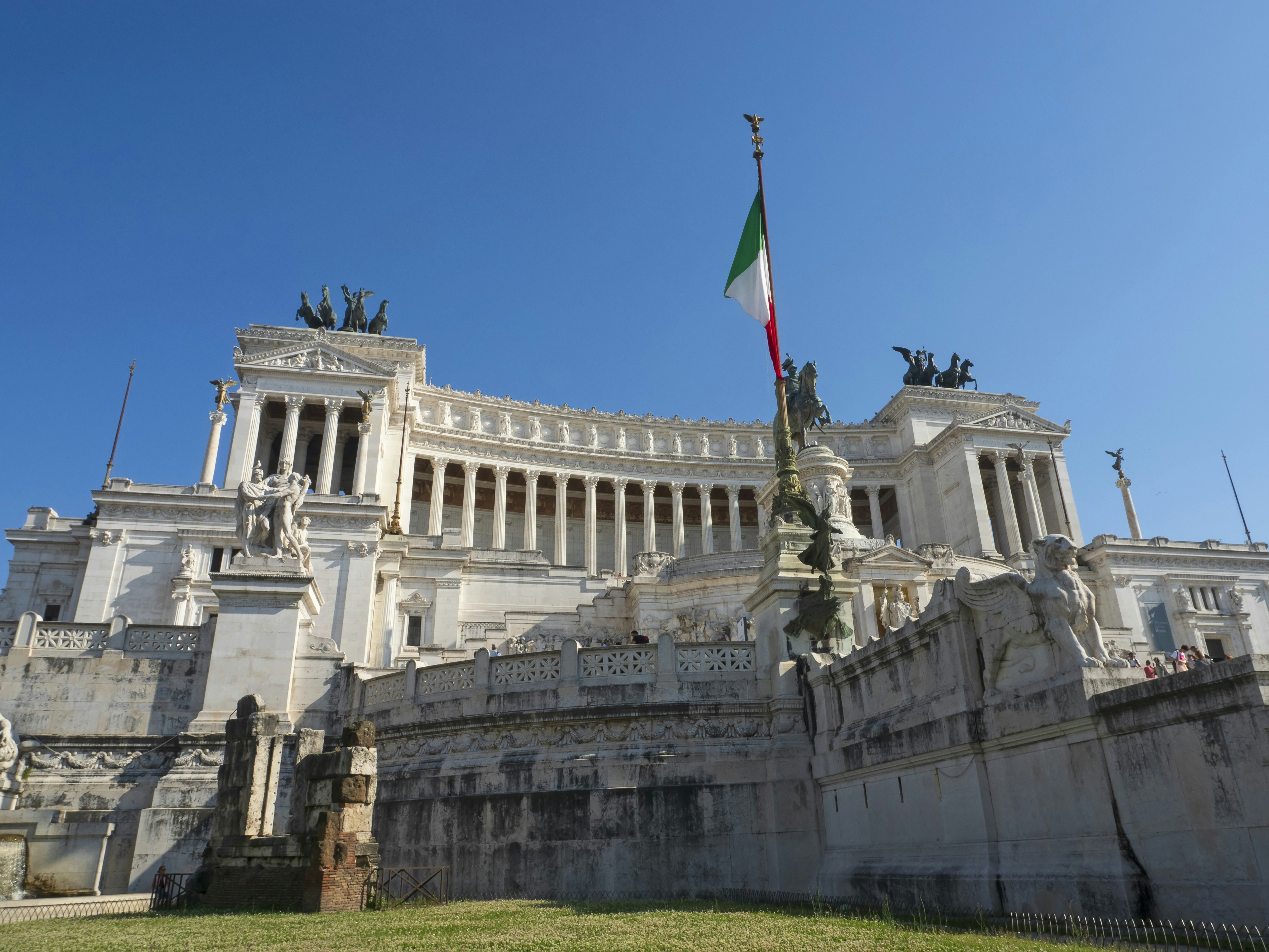 a building with statues and a flag