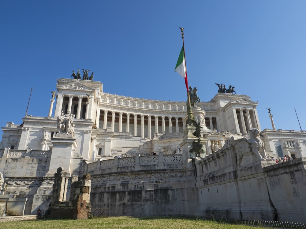 a building with statues and a flag