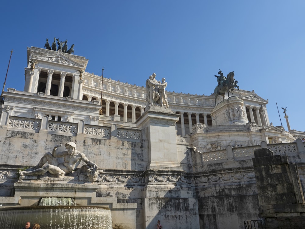 a large stone building with statues on top