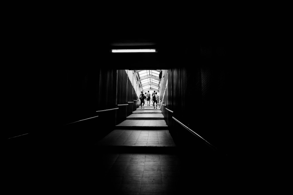 a group of people walking down a hall way