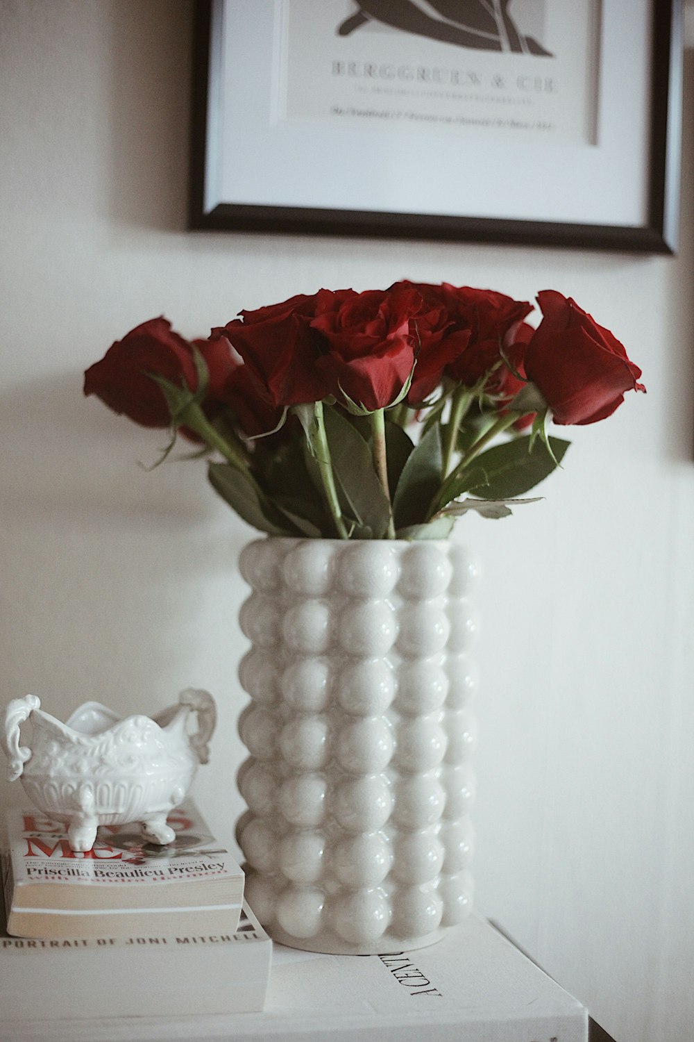 a vase with red roses