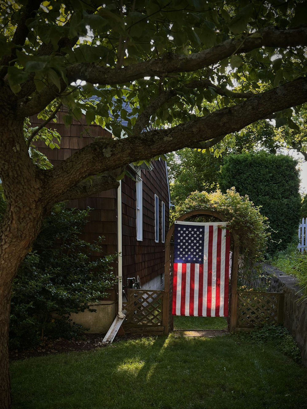 a small wooden house with a flag from a tree