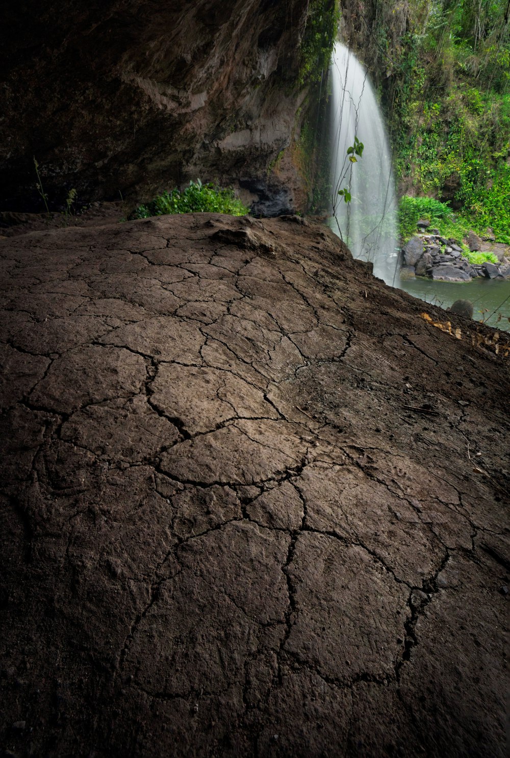 a large rock with a waterfall