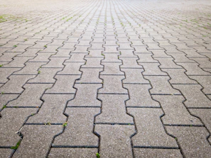 a cobblestone road with a brick walkway