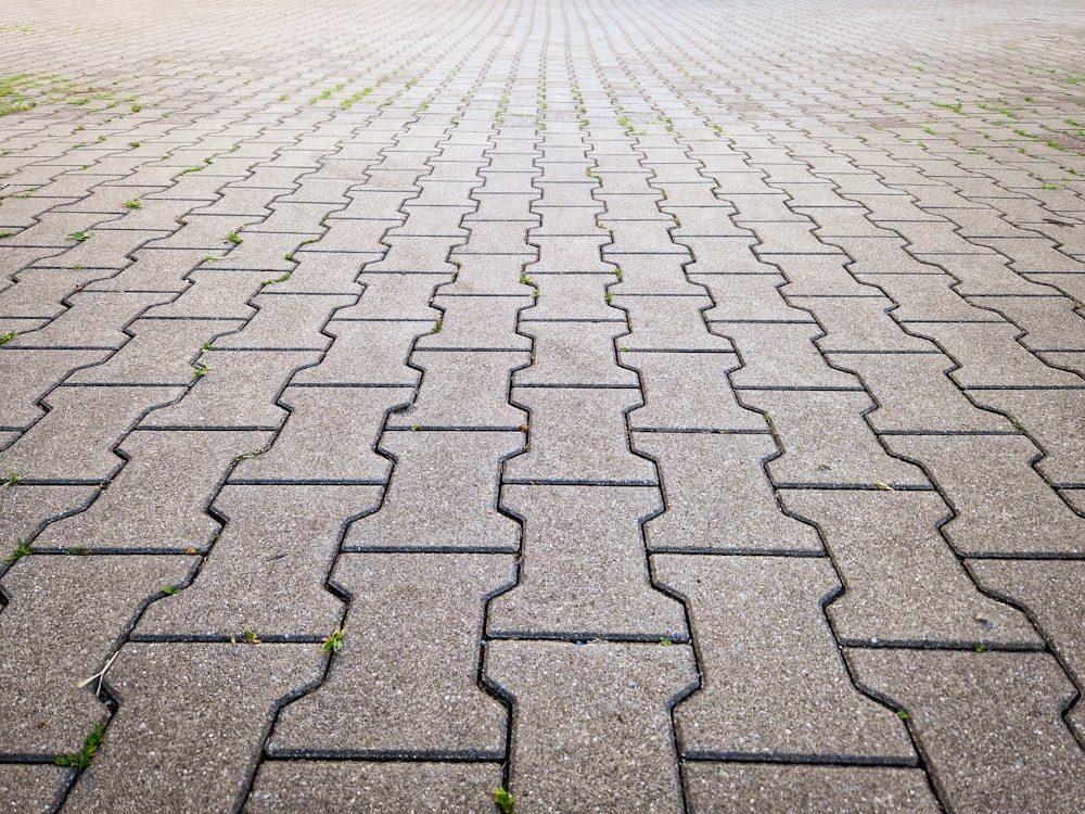 a cobblestone road with a brick walkway