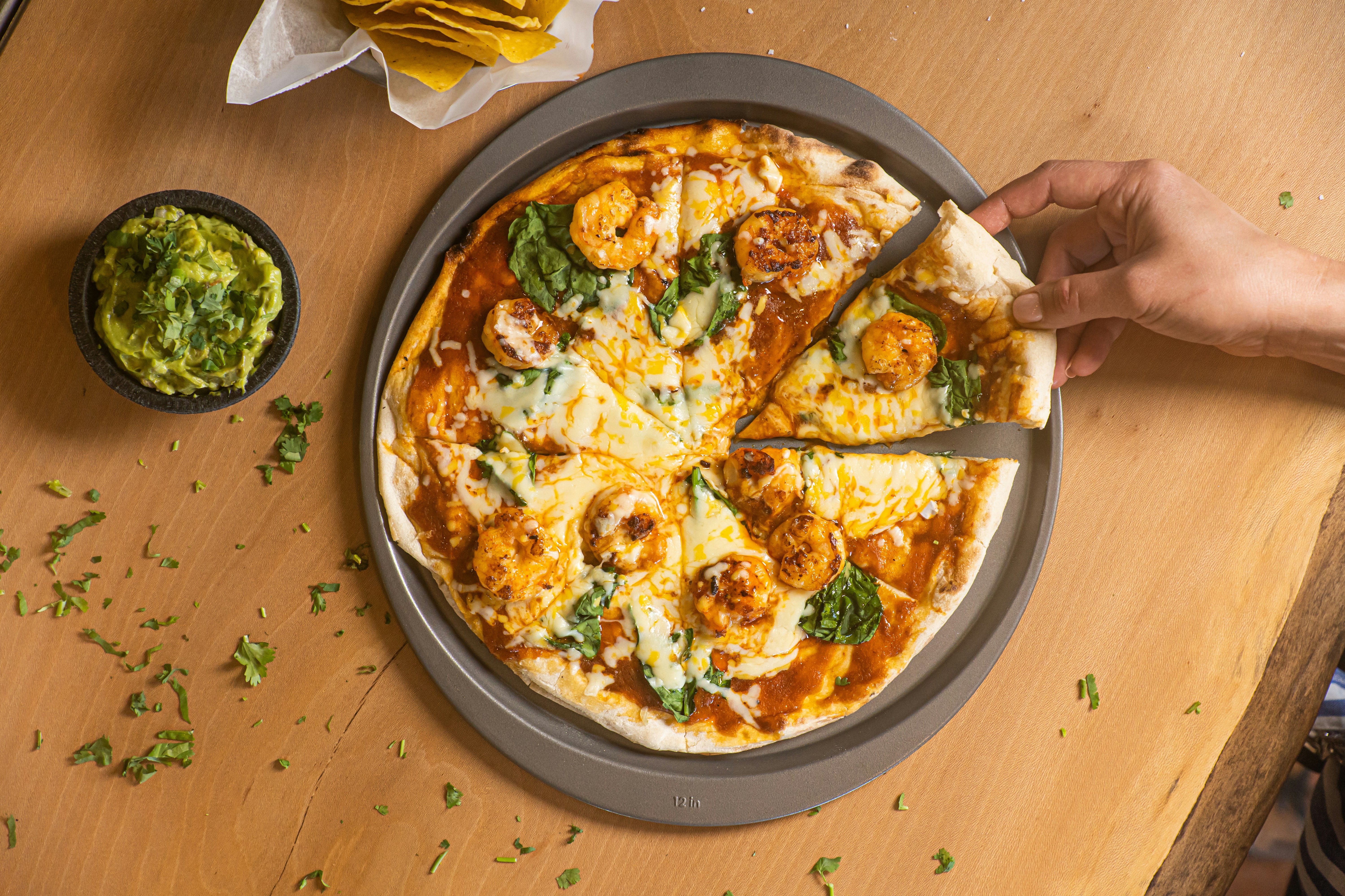 a person cutting a pizza