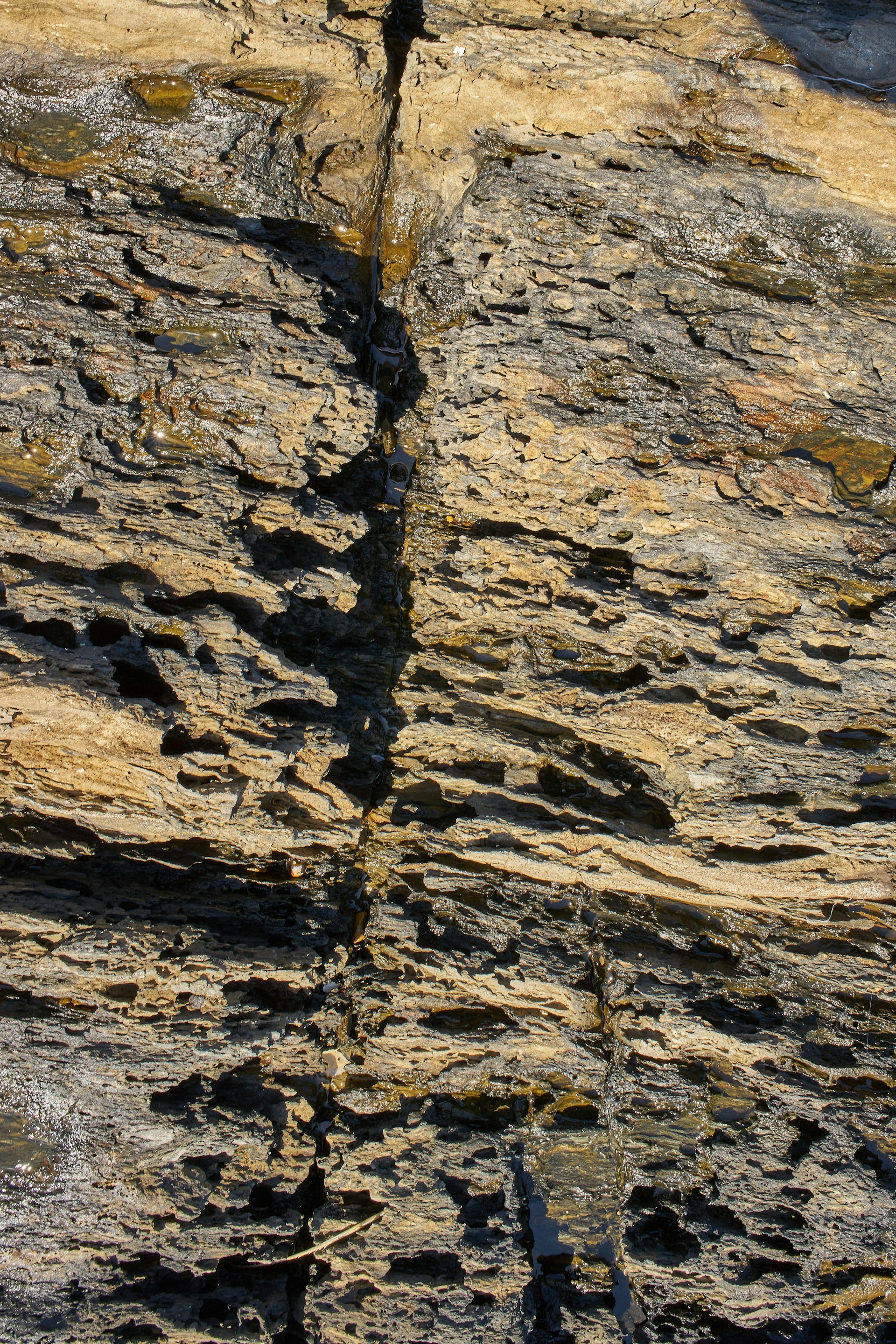 a rocky area with a hole in it