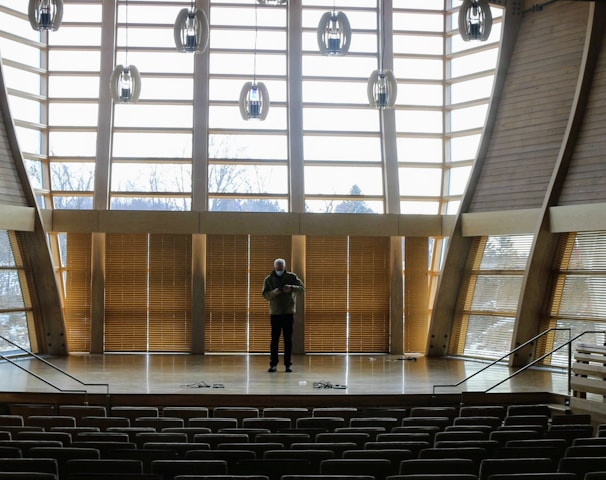 a person standing in a large empty auditorium