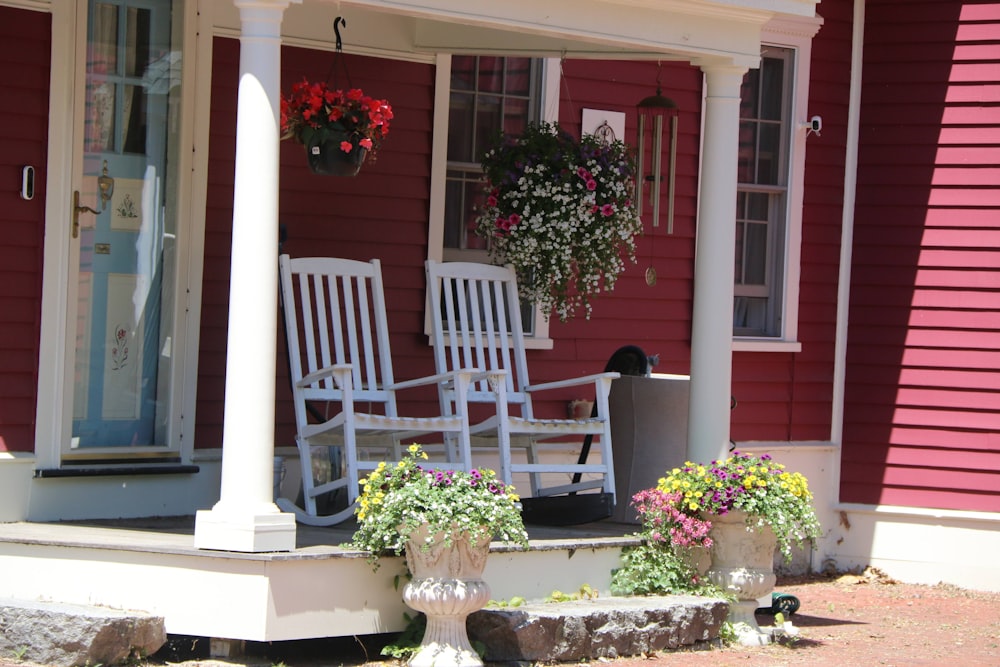 a white bench sits in front of a pink house