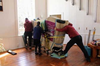a group of people working on a horse