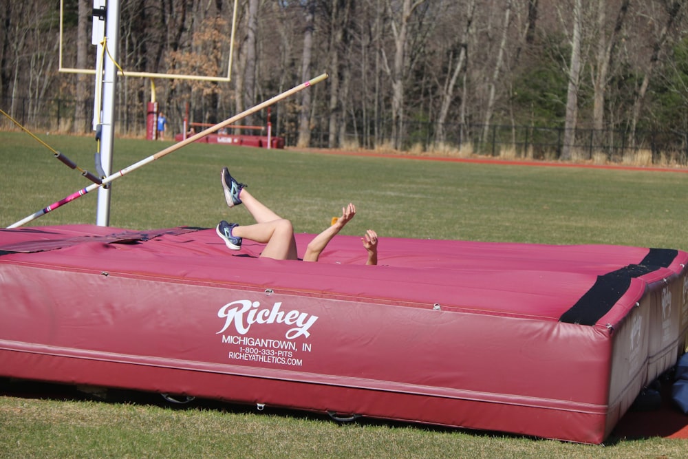 a person jumping over a trampoline