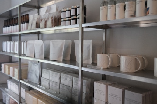 a shelf with many white containers on it