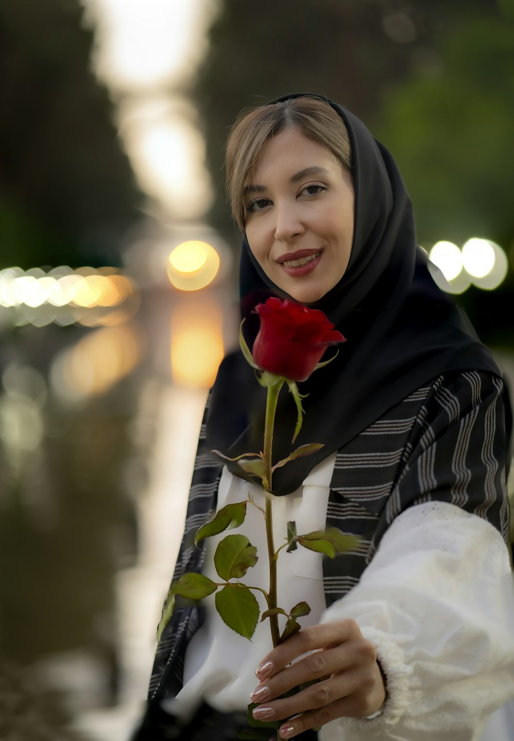 a person holding a rose