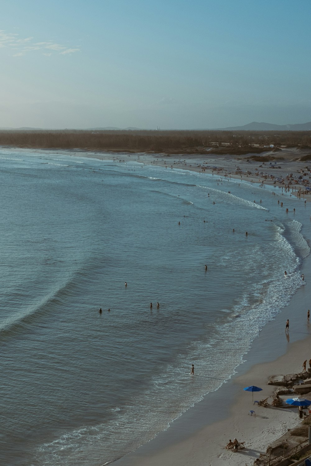 a beach with people swimming in it