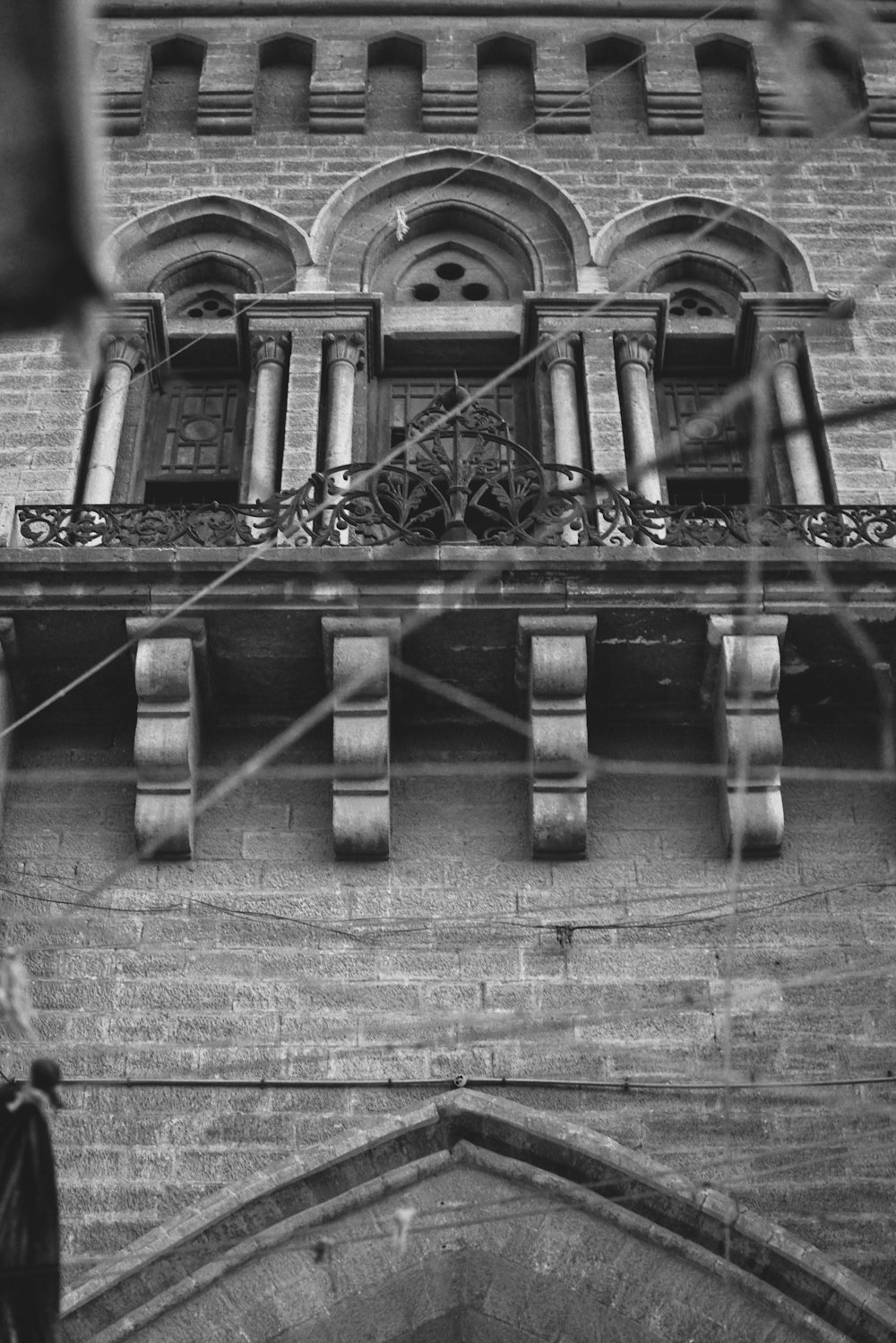 a black and white photo of a building with a balcony