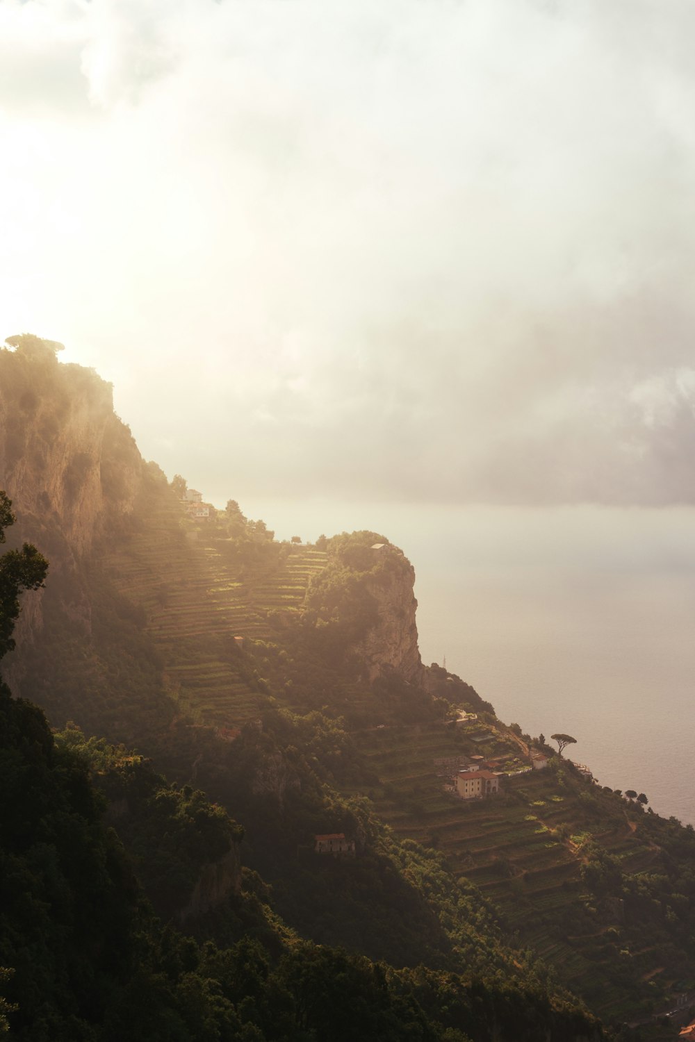 a foggy valley with buildings and trees