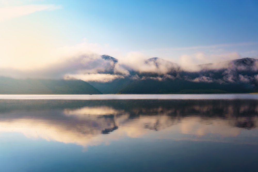 a body of water with clouds above it