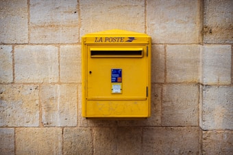 a yellow box on a brick wall