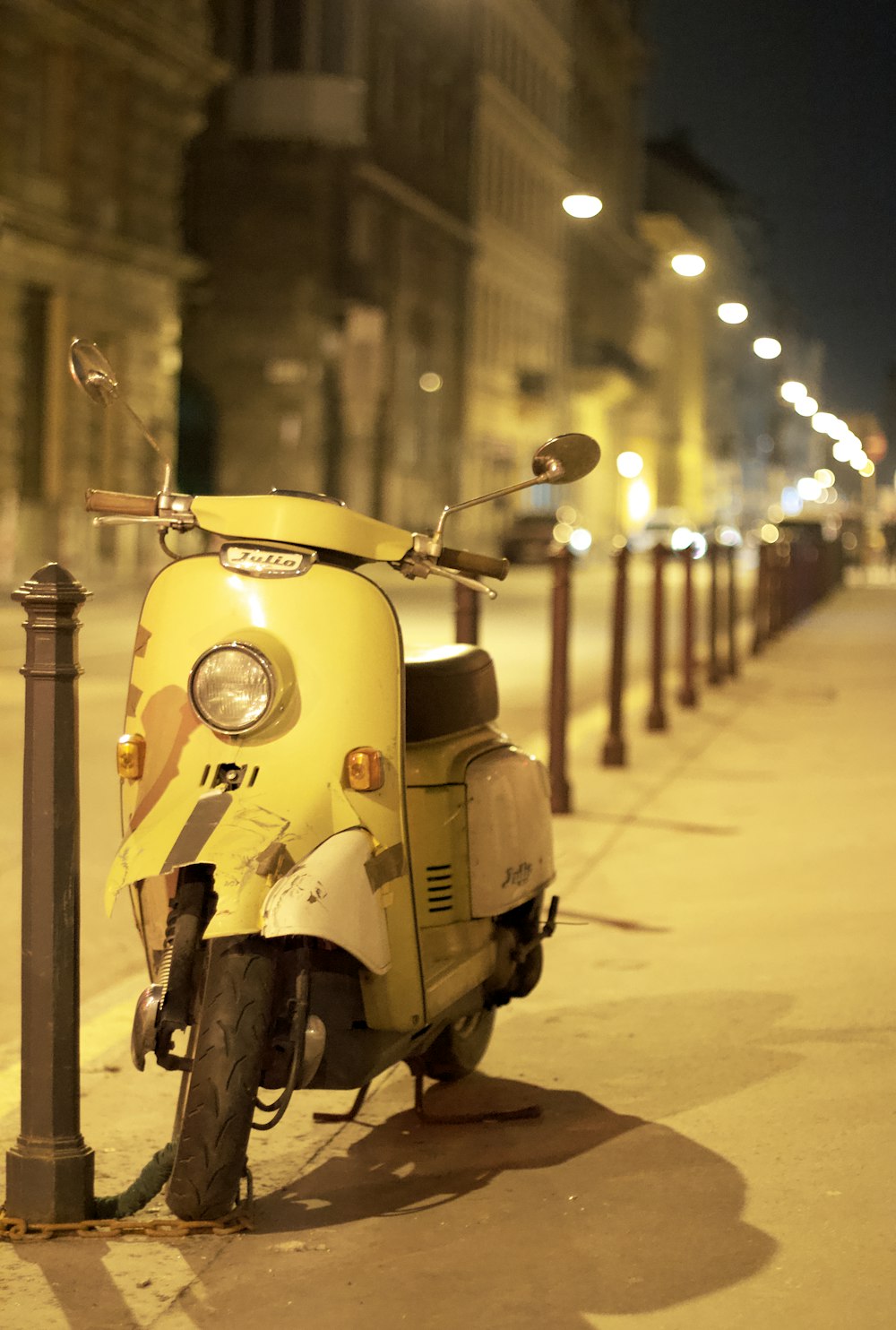 a scooter parked on the side of a street