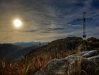 A film crew filming a heartfelt biblical scene outdoors at sunset.